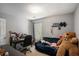 Guest bedroom with a blue couch, desk and chair at 30 Crestfield Cir, Covington, GA 30016