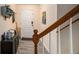 Inviting entryway featuring hardwood floors, staircase, and a convenient storage unit at 30 Crestfield Cir, Covington, GA 30016