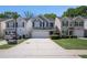 Exterior view of a well-maintained home with a two-car garage and a neatly landscaped front yard at 30 Crestfield Cir, Covington, GA 30016