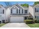 Charming home with a two-car garage, gray siding, black shutters, and well-maintained landscaping at 30 Crestfield Cir, Covington, GA 30016