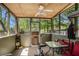 Screened in porch area with table, chairs, and ceiling fan at 30 Crestfield Cir, Covington, GA 30016
