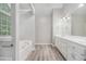 Bright bathroom featuring a soaking tub, double sink vanity, and a large arched window at 314 Sable Trace Pass, Acworth, GA 30102