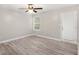 Well-lit bedroom featuring wood-look floors, a ceiling fan, and access to the backyard through a door at 314 Sable Trace Pass, Acworth, GA 30102