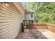 Home exterior featuring a wood deck and screened-in porch overlooking a wooded area with mature trees at 314 Sable Trace Pass, Acworth, GA 30102