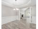 Dining room featuring a tray ceiling, decorative chandelier, fireplace and luxury vinyl flooring at 314 Sable Trace Pass, Acworth, GA 30102