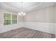 Dining room featuring a decorative chandelier, luxury vinyl flooring, and window view at 314 Sable Trace Pass, Acworth, GA 30102