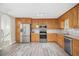 Kitchen featuring wood cabinets, stainless steel appliances, and luxury vinyl flooring at 314 Sable Trace Pass, Acworth, GA 30102