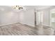 Spacious open-concept living room with wood-look flooring, recessed lights, and multiple entrances at 314 Sable Trace Pass, Acworth, GA 30102