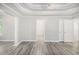 A versatile living room with tray ceiling, neutral paint, and hardwood flooring throughout at 314 Sable Trace Pass, Acworth, GA 30102