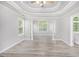 Open living room features a tray ceiling, ceiling fan, and plenty of natural light at 314 Sable Trace Pass, Acworth, GA 30102