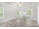 Bright living room with a tray ceiling, ceiling fan, and large windows offering natural light at 314 Sable Trace Pass, Acworth, GA 30102