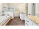Bathroom featuring tiled shower with glass door, bathtub, wood flooring and granite countertops at 3541 Haddon Hall Dr, Buford, GA 30519