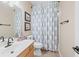 Cozy bathroom with a vanity, toilet, and shower-tub combo behind a patterned shower curtain at 3541 Haddon Hall Dr, Buford, GA 30519