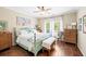 Comfortable bedroom with decorative bed frame, wood floors, and natural lighting from two windows at 3541 Haddon Hall Dr, Buford, GA 30519