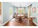 Dining room features a wooden table with seating for six, wood floors, a chandelier, and natural light at 3541 Haddon Hall Dr, Buford, GA 30519