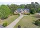Traditional brick home with a well-manicured lawn and driveway surrounded by mature trees at 3541 Haddon Hall Dr, Buford, GA 30519