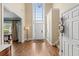 Welcoming foyer features hardwood floors, staircase, statement lighting, and access to multiple rooms at 3541 Haddon Hall Dr, Buford, GA 30519