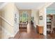 Bright foyer with hardwood floors, staircase, decorative wreath, and clear view to living room with soaring window at 3541 Haddon Hall Dr, Buford, GA 30519