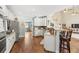 Open kitchen with stainless steel appliances, granite countertops, and a breakfast bar overlooking the living area at 3541 Haddon Hall Dr, Buford, GA 30519