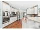 Open eat-in kitchen featuring a center island with bar stool seating, hardwood floors, and modern appliances at 3541 Haddon Hall Dr, Buford, GA 30519