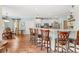 Bright eat-in kitchen featuring a center island with bar stool seating, hardwood floors, and modern appliances at 3541 Haddon Hall Dr, Buford, GA 30519