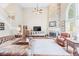 Grand living room features stone fireplace, hardwood floors, and luxurious seating for entertaining at 3541 Haddon Hall Dr, Buford, GA 30519