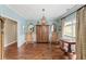 Formal living room boasts hardwood floors, wainscoting, antique furniture and a tranquil ambiance at 3541 Haddon Hall Dr, Buford, GA 30519