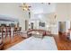 Spacious living room with high ceilings, a staircase, wood floors, leather sofa, and open kitchen at 3541 Haddon Hall Dr, Buford, GA 30519