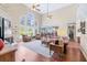 Spacious living room with stone fireplace, hardwood floors, and picturesque windows overlooking the backyard at 3541 Haddon Hall Dr, Buford, GA 30519