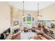 Bright living room boasts high ceilings, fireplace, and large windows overlooking the pool and backyard at 3541 Haddon Hall Dr, Buford, GA 30519