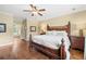 Main bedroom suite featuring a king bed, hardwood floors, and an ensuite bathroom at 3541 Haddon Hall Dr, Buford, GA 30519