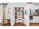 Walk-in pantry featuring custom shelving and ample storage space, adjacent to a kitchen with double ovens at 3541 Haddon Hall Dr, Buford, GA 30519