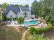 Backyard oasis with a large freeform pool, hot tub, stone waterfall and lounge seating at 3541 Haddon Hall Dr, Buford, GA 30519