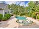 Custom pool with built-in sun loungers, a spa, and lush landscaping for a relaxing backyard retreat at 3541 Haddon Hall Dr, Buford, GA 30519