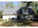 View of backyard with patio furniture, grill, and trampoline and a large grassy lawn at 4314 Saddlecreek Ct, Auburn, GA 30011