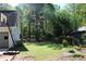 This home offers a spacious backyard surrounded by mature trees, perfect for outdoor activities at 4314 Saddlecreek Ct, Auburn, GA 30011