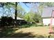 Fenced backyard view of a large grassy lawn with an outbuilding behind the main house at 4314 Saddlecreek Ct, Auburn, GA 30011