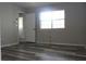 Bedroom showcasing a sunny window, neutral walls, and vinyl flooring at 4314 Saddlecreek Ct, Auburn, GA 30011