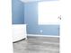 Bedroom with blue walls, grey flooring and a white dresser by the window at 4314 Saddlecreek Ct, Auburn, GA 30011