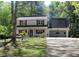 Charming two-story home featuring red shutters, a well-manicured lawn, and an attached two-car garage at 4314 Saddlecreek Ct, Auburn, GA 30011