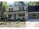 Charming two-story home featuring red shutters, a well-manicured lawn, and an attached two-car garage at 4314 Saddlecreek Ct, Auburn, GA 30011