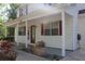 Inviting front porch with red door and shutters, surrounded by lush landscaping and a paved walkway at 4314 Saddlecreek Ct, Auburn, GA 30011