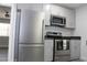 Kitchen with stainless steel appliances, grey cabinets, and view to adjacent space at 4314 Saddlecreek Ct, Auburn, GA 30011