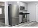 Kitchen with stainless steel appliances, grey cabinets, and view to adjacent space at 4314 Saddlecreek Ct, Auburn, GA 30011