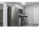 Updated kitchen features stainless steel appliances and gray cabinets and floors at 4314 Saddlecreek Ct, Auburn, GA 30011