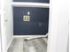 Bare laundry room with navy walls and updated floor at 4314 Saddlecreek Ct, Auburn, GA 30011