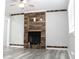 Bright living room with wood flooring and a modern fireplace with reclaimed wood accent wall at 4314 Saddlecreek Ct, Auburn, GA 30011
