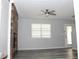 Bright living room with wood flooring, ceiling fan, and a modern fireplace with reclaimed wood accent wall at 4314 Saddlecreek Ct, Auburn, GA 30011
