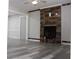 Bright living room with wood flooring and a modern fireplace with reclaimed wood accent wall at 4314 Saddlecreek Ct, Auburn, GA 30011