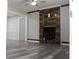 Bright living room with wood flooring and a modern fireplace with reclaimed wood accent wall at 4314 Saddlecreek Ct, Auburn, GA 30011